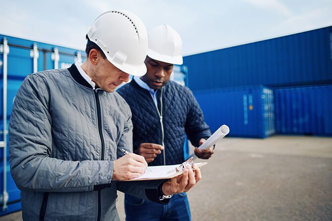 two engineers standing in a shipping yard discussing 3pl logistics projects