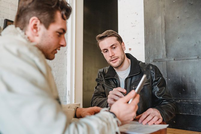 A person consulting with their customer to reduce supply chain cost