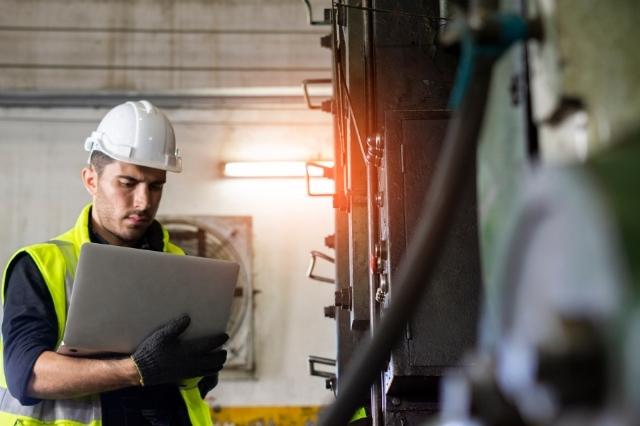 A worker in front of a machine